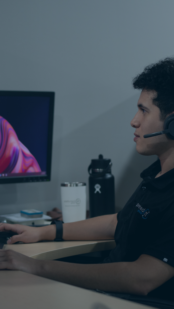 A man with a headset is diligently working on a computer, showcasing a professional environment.